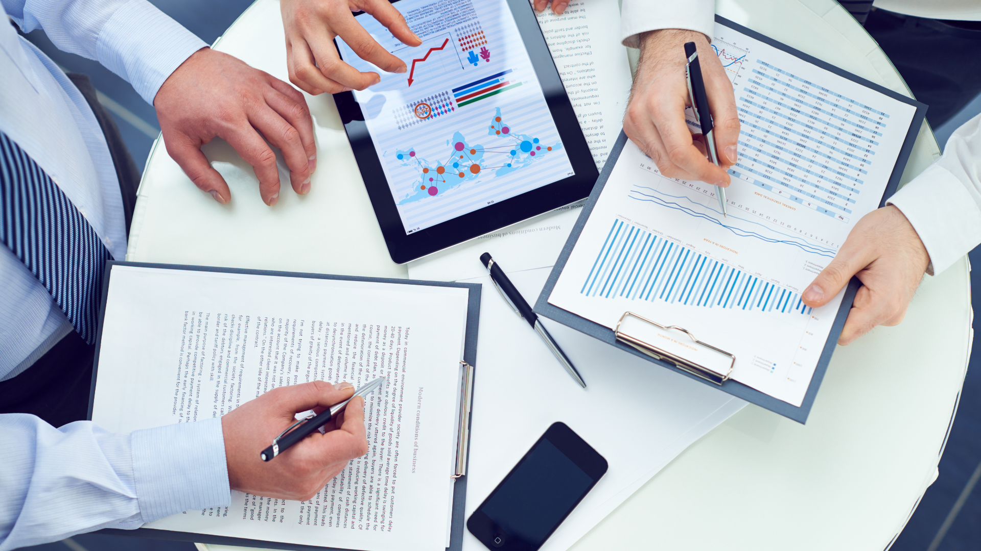 Analysts reviewing portfolio charts and reports