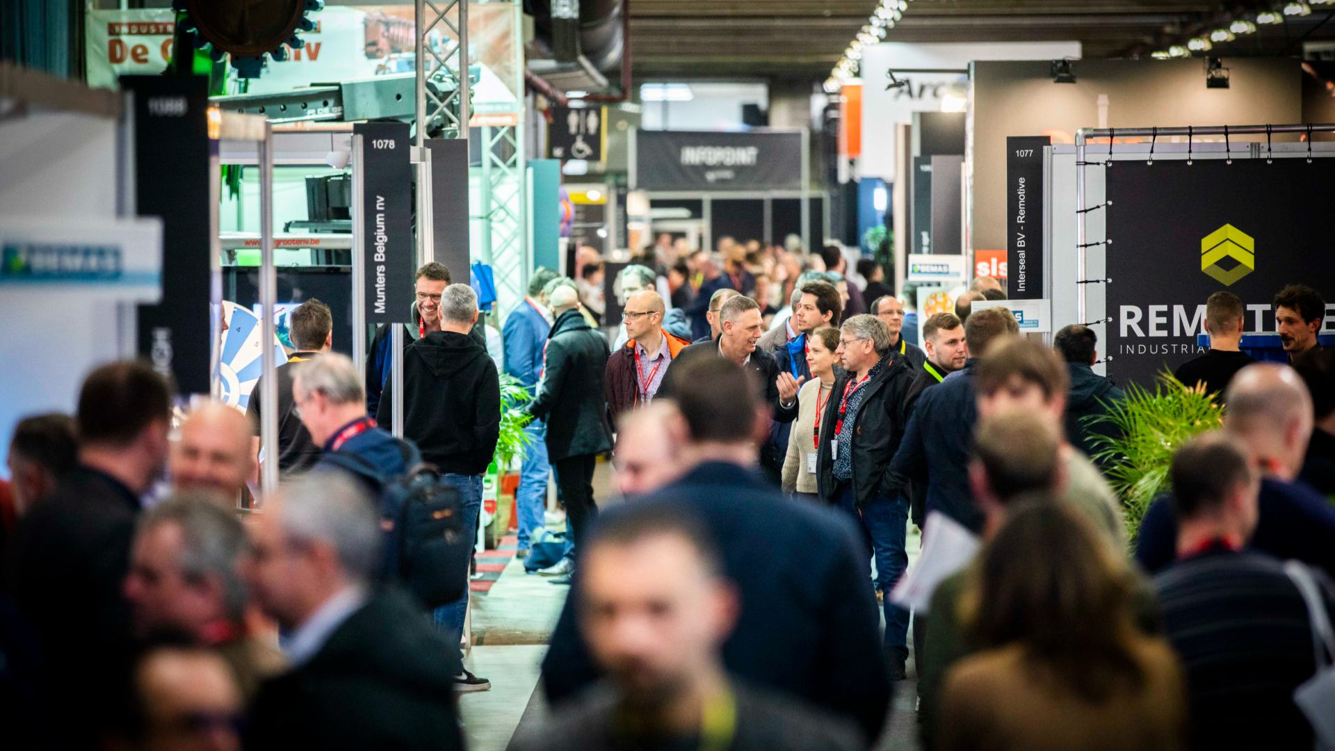 Visitors and exhibitors meeting on a trade show floor